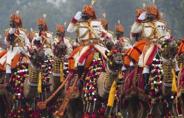 Indian military personnel salute while riding camels during the Republic Day Parade in Delhi on January 26, 2015