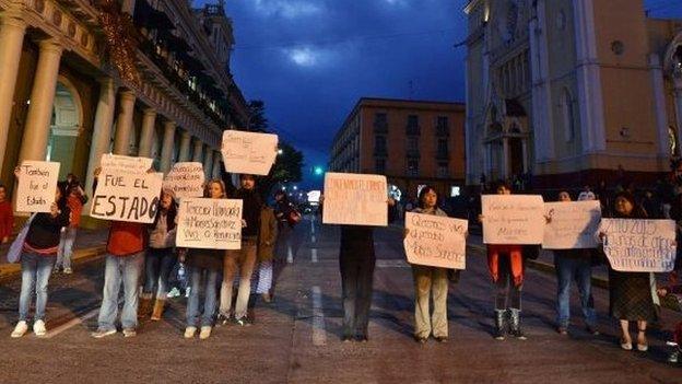 Journalists hold signs demanding the safe return of colleague Moises Sanchez during a protest in Xalapa on 7 January 7, 2015.