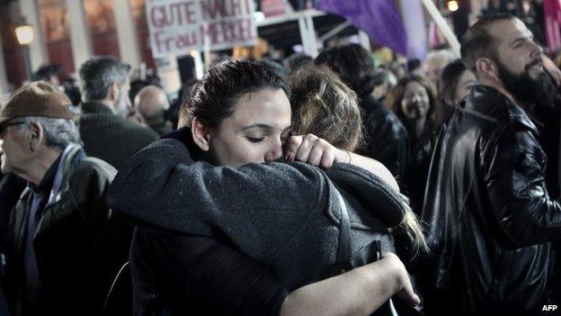 Anti austerity Syriza party supporters celebrate as leader Alexis Tsipras speaks following victory in the election in Athens on January 25, 2015