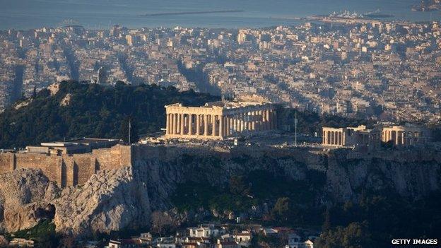 The sun begins to rise over Athens and the Acropolis seen from the summit of Mount Lycabettus following the electoral success by Syriza in the Greek general election yesterday on January 26, 2015 in Athens, Greece