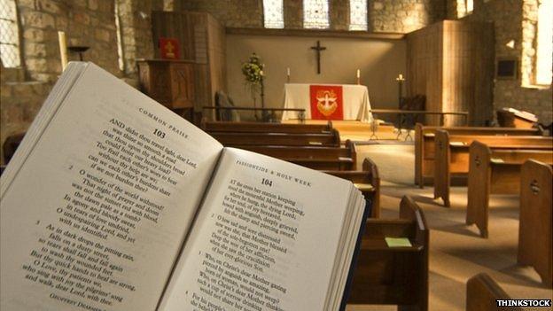 Prayer book held up inside an Anglican church