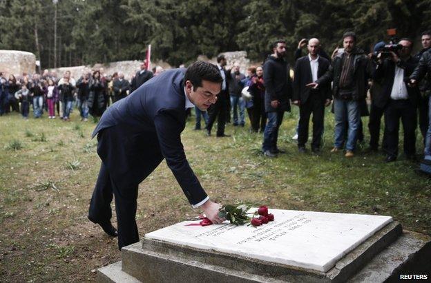 Alexis Tsipras lays flowers at a war memorial in Athens, 26 January