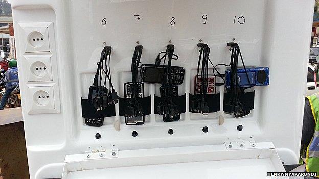 Phones being charged at a mobile solar powered charging station