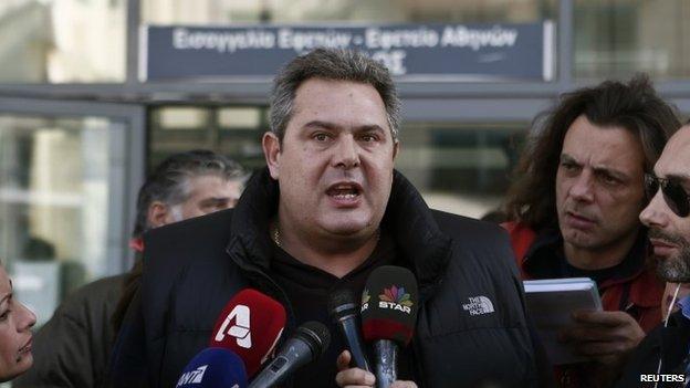 Leader of the Independent Greeks party Panos Kammenos speaks to members of the media as he arrives at a prosecutor"s office to give a testimony in Athens December 21, 2014