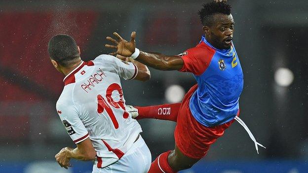 Tunisia forward Ahmed Akaichi (left) jumps to head the ball with DR Congo defender Issama Mpeko