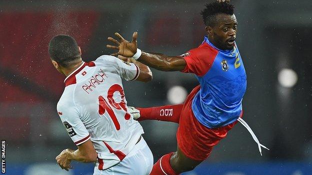 Tunisia forward Ahmed Akaichi (left) jumps to head the ball with DR Congo defender Issama Mpeko