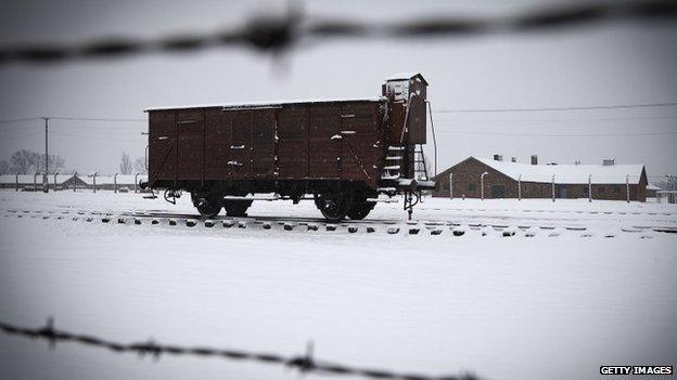 Snows falls on a train car at the memorial site of the former Nazi concentration camp Auschwitz-Birkenau.