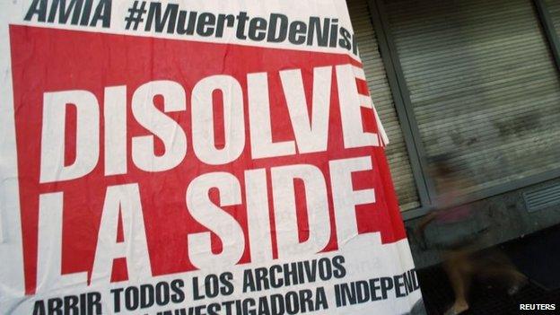 A poster reads "Dissolve the SIDE" in Buenos Aires on 26 January, 2015.