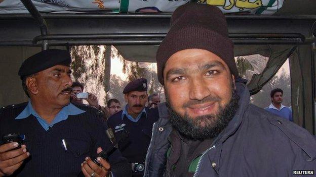 Mumtaz Qadri smiles after being detained at the site of Taseer's shooting in Islamabad 4 January 2011