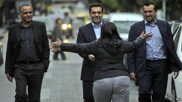 Alexis Tsipras is hugged by a supporter (26 Jan)