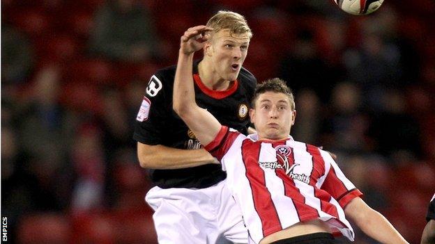 Crewe centre-half Harry Davis tussles with Alex old boy Shaun Miller