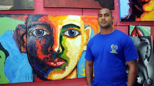 Myuran Sukumaran at a prisoner studio inside Bali's Kerobokan prison on 28 September 2011 in front of his paintings.