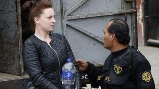 Michaella McCollum in handcuffs with a prison escort in Lima, Peru, in 2013