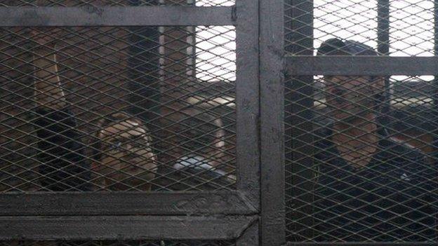 Egyptian prominent activists Ahmed Douma (R) and Ahmed Maher (L)react as they stand in the dock during their failed appeal on 7 April 2014