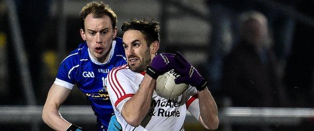 Mark Donnelly battles with Cavan's Martin Reilly in Saturday's McKenna Cup final