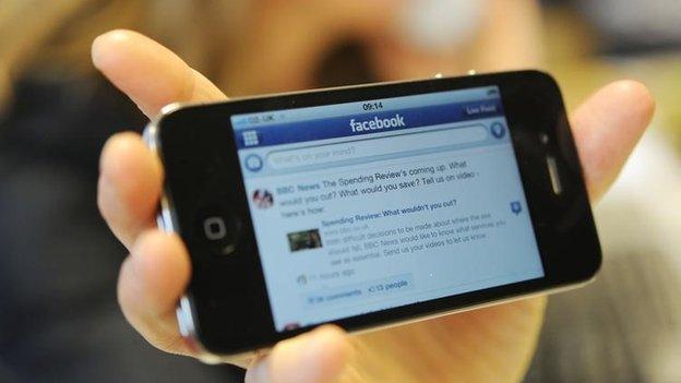 Mobile phone with Facebook on the screen