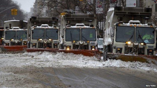 A line of snow plows make their way down 5th Avenue during what would normally be a busy rush hour morning following Winter Storm Juno in the Manhattan borough of New York January 27, 2015.