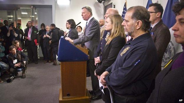 New York City Mayor Bill de Blasio, center, and top city officials hold press conference at the city"s Office of Emergency Management, Monday, Jan. 26, 2015, in New York