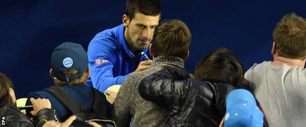 Novak Djokovic signs autographs after his straight-sets win