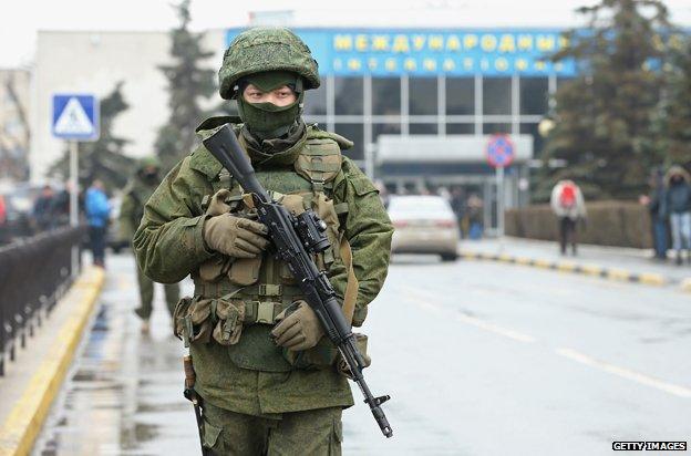 Soldiers, who were wearing no identifying insignia and declined to say whether they were Russian or Ukrainian, patrol outside the Simferopol International Airport, February 2014