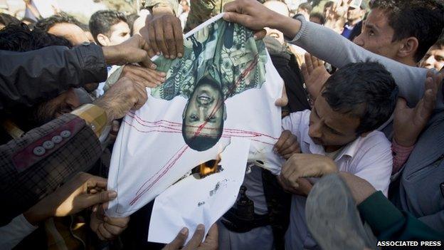 Protesters burned a poster of Abdul-Malik al-Houthi, a leader of Shiite rebels who hold the capital, Sanna, during a demonstration on 24 January 2015