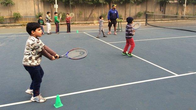 Children at a tennis lesson