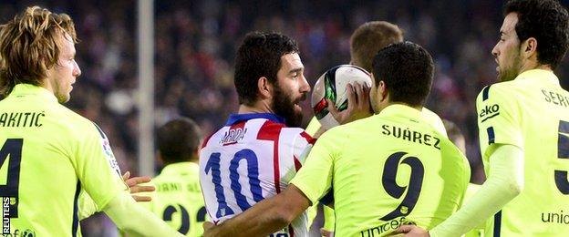 Arda Turan is led away by Barcelona players