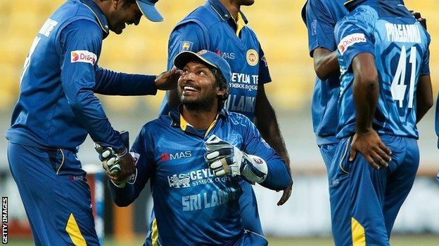 Dimuth Karunaratne shakes the hand of Kumar Sangakkara