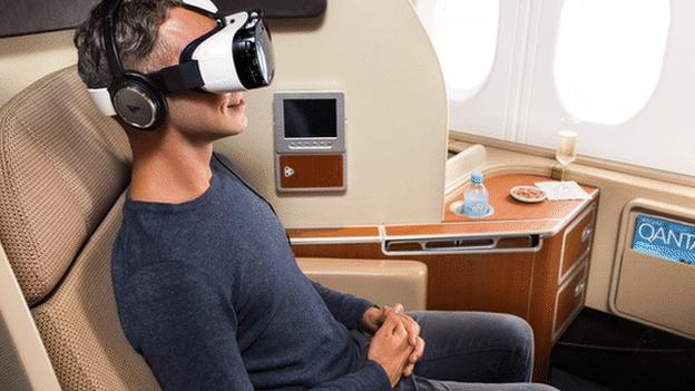 Man on plane wearing Samsung Gear virtual reality headset