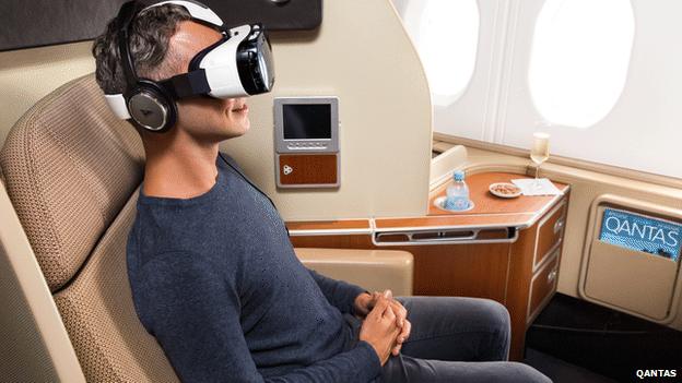 Man on plane wearing Samsung Gear virtual reality headset