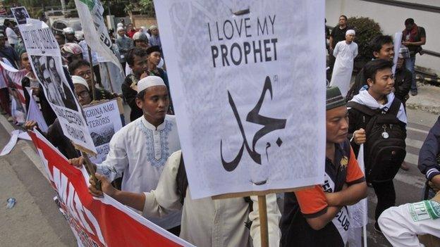 Indonesian Muslim men display posters during a protest against the caricature of Prophet Muhammad published in French satirical weekly Charlie Hebdo, outside the local office of French Alliance in Medan, North Sumatra, Indonesia, 23 January 2015.