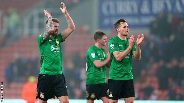 Wrexham players sport their away kit in their recent FA Cup tie at Stoke City