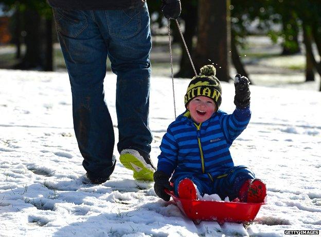 Happy little boy on sledge