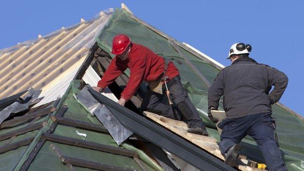 Builders on a roof