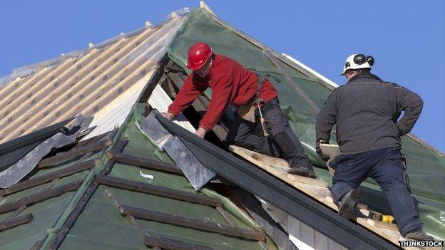 Builders on a roof