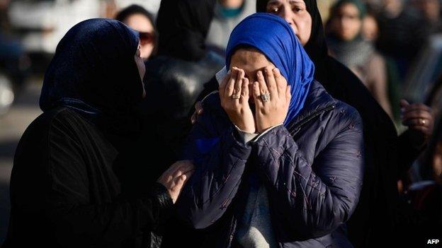 Relatives of the victims of Thursday's attacks in El-Arish at military airport where bodies were flown, 30 January 2015