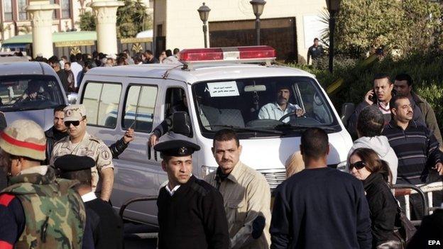 An ambulance carries the coffin of a soldier after the funeral for some of the 30 killed in Sinai attack, al-Maza military airport, Egypt, 30 January 2015.