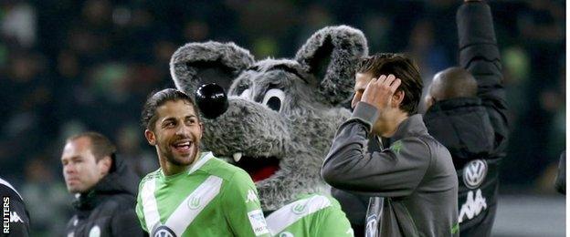 Wolfsburg players and mascot