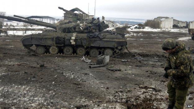 A Ukrainian soldier examines a crater after shelling near Debaltseve. Photo: 29 January 2015