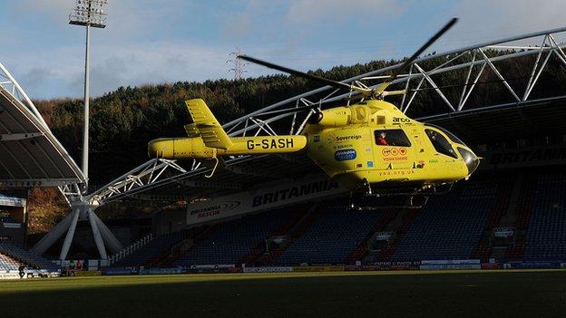 A helicopter takes Huddersfield's Tommy Smith to hospital