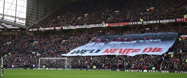 A banner is displayed at Old Trafford as Manchester United commemorate the 57th anniversary of the Munich Air Disaster before kick-off