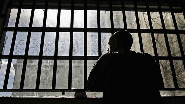 An inmate looking out from prison