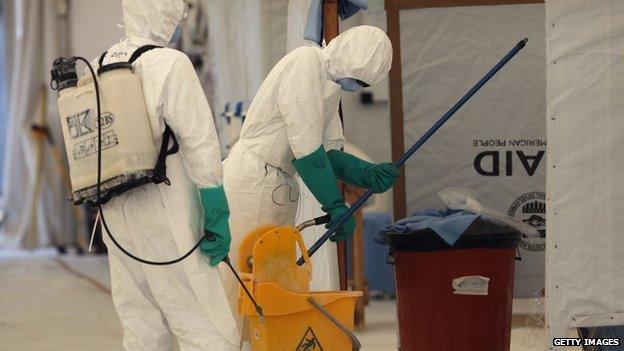 Health workers for the International Organisation for Migration prepare to clean a high-risk section of the Ebola Treatment Unit (ETU) near Tubmanburg (29 January 2015)