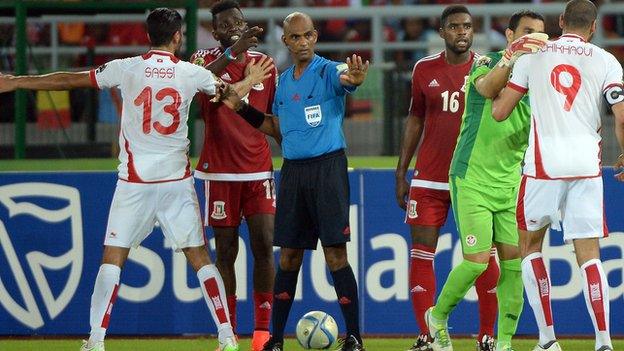 Referee Rajindraparsad Seechur tried to keep control of the Tunisia v Equatorial Guinea match