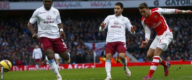 Mesut Ozil (right) scores for Arsenal