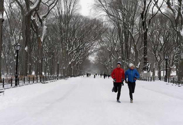 Two men running through snow