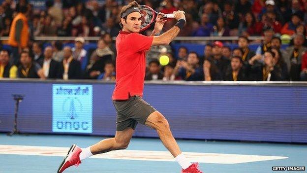 Roger Federer plays a backhand