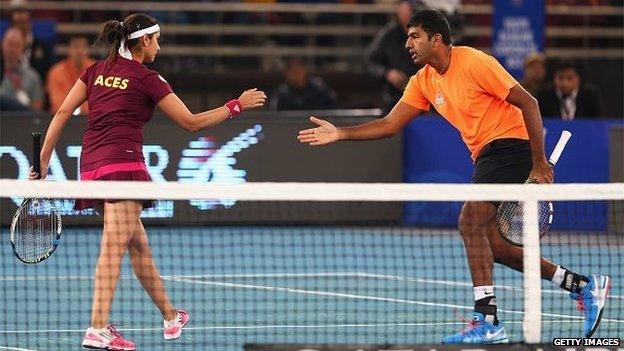 Rohan Bopanna celebrates a shot on court with his doubles partner Sania Mirza