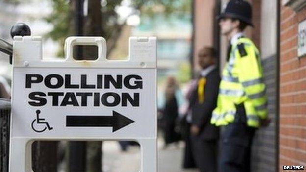 A police officer stands outside a polling station in Tower Hamlets