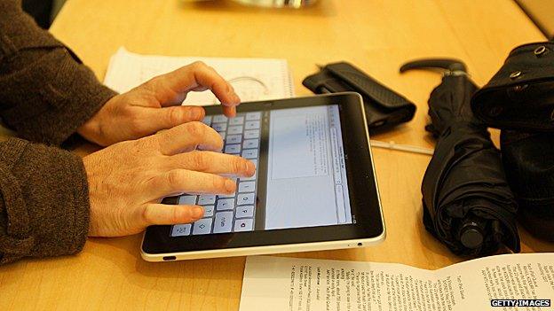 Man writes email on an iPad